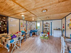 a classroom with tables and chairs in a room at Cottage, animaux acceptés - 6 pers. - API-1-52-2931 in Lamonzie-Montastruc