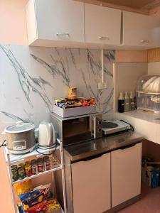 a small kitchen with a counter top and a counter top at Maple Tree by The Guild Oasis Transient House in Rosario