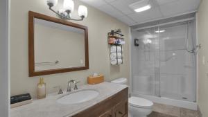 a bathroom with a sink and a shower with a mirror at Waterfront, Hot Tub, Dock Kayaks, Movie Game Room in Lake Ariel +39 photos