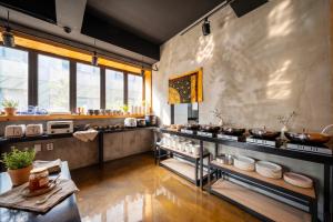 a restaurant with dishes on display in a room at Restia Hotel Suwon Station in Suwon