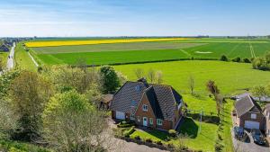 an aerial view of a house and a field at Fewo-Inselblick in Nordstrand