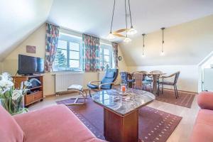 a living room with a couch and a table at Fewo-Inselblick in Nordstrand