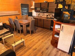 a kitchen and dining room with a table and chairs at Domek Nad Morzem in Kołobrzeg