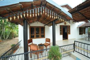 a home with a pergola and a patio at Secret Ashram Coorg in Kushālnagar