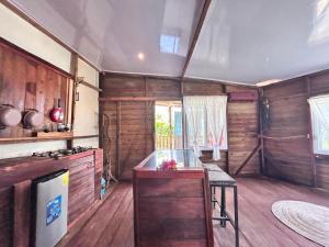 a kitchen with wooden walls and a counter and a stove at Coco cabañas Tela in El Triunfo de la Cruz