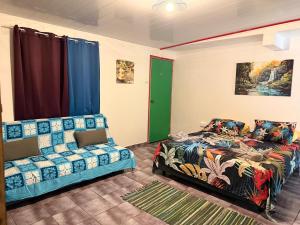 a living room with a bed and a couch at Lemon House Huahine in Maroe