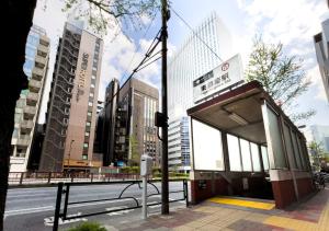 a bus stop on the side of a city street at Super Hotel Premier Ginza in Tokyo