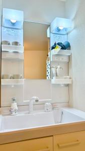 a bathroom with a sink and a mirror at Ueno Sakura Inn 上野公园 in Tokyo +55 photos