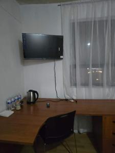 a desk with a computer monitor on top of it at Recamara tipo cabaña in Mexico City
