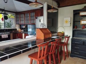 a kitchen with a counter and some chairs in a room at Enjoy Cabo del Sol Costa del Sol in El Zapote