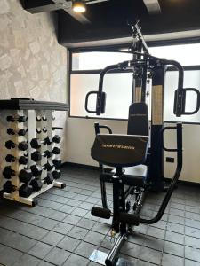 a gym with a chair in a room with wine racks at Hotel Ryo 74B Suites by Growing Group in Medellín