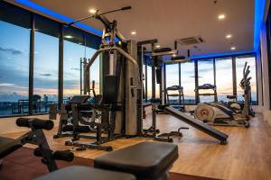 a gym with cardio equipment in a building at Opulent Nights Sky Hotel 2BR Family Stay KK in Kota Kinabalu