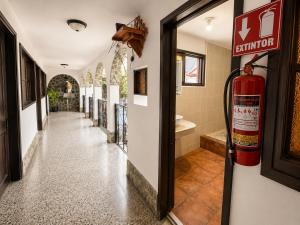 a hallway with a fire hydrant in a house at Casa de la Torre in Antigua Guatemala