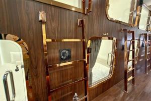a room with wood paneled walls and mirrors at The Rich Cafe & Hostel in Pattaya South