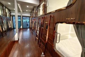 a room with a row of shelves in a boat at The Rich Cafe & Hostel in Pattaya South +14 photos