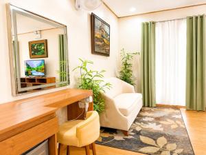 a living room with a mirror and a couch at Sky Garden Homestay in Olongapo