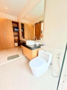 a bathroom with a toilet and a sink at Bella Villa V1 in Koh Lone +19 photos