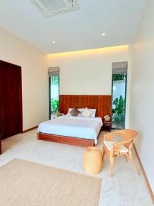 a bedroom with a bed and a table at Bella Villa V1 in Koh Lone