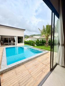 a swimming pool with a view of a house at Bella Villa V1 in Koh Lone