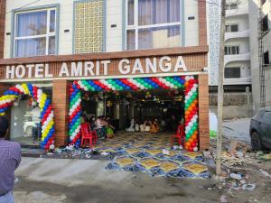a hotel amitri ganga with a colorful arch in front of a building at Hotel Shree Amrit Ganga in Haridwār