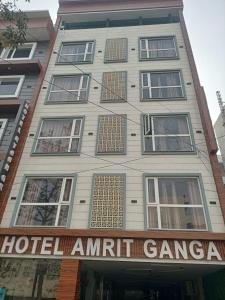 a building with a hotel amitt goma sign on it at Hotel Shree Amrit Ganga in Haridwār
