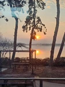a picnic table with the sunset in the background at Muan Topmeori Pension in Muan