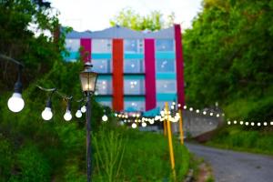 a building with a lot of lights and a street light at Pygmalion Effect in Chuncheon