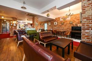 a restaurant with couches and tables and a brick wall at Pygmalion Effect in Chuncheon