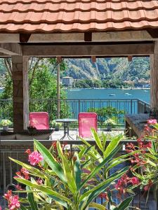 a patio with chairs and a table and a view of the water at Holiday house in Kotor