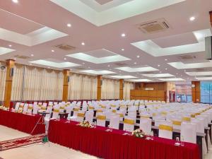 a large room with rows of tables and chairs at Nhà Khách TW in Hanoi