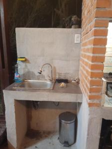 a sink in a brick wall with a trash can at Tu lugar de relax a 2 cuadras de la playa Se reserva con seña in Guazuvira +30 photos