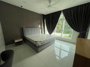 a bedroom with a bed and a large window at Homestays Batu Ferringhi in Batu Ferringhi