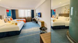 a hotel room with two beds and a mirror at Holiday Inn Express Zhangye by IHG in Zhangye +26 photos
