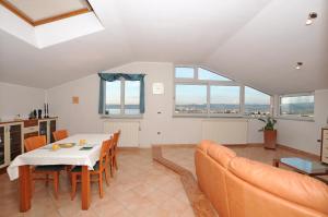 a living room with a table and a couch at Koperinn in Koper