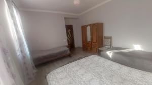 a bedroom with two twin beds and a closet at Gohar Bed and Breakfast in Tatʼev