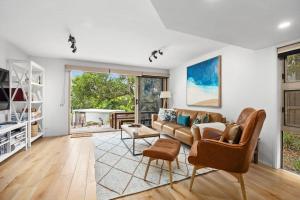 a living room with a couch and a table at Peregian Beach Apartment in Peregian Beach