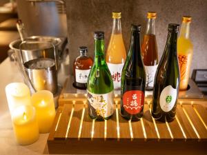 a group of wine bottles sitting on a cutting board at Super Hotel Premier Ginza in Tokyo +61 photos