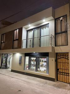 a building with a balcony on top of it at Olive Loft - Local Sensory and Boutique Experience in Tacna
