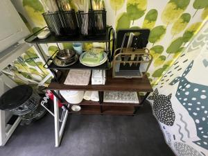 a shelf with utensils on it next to a bed at 愛犬と泊まるグランピングJuden Camp Fuji in Yamanakako