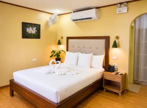 a bedroom with a bed with a swan on it at Sky Garden Homestay in Olongapo