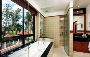 a bathroom with a tub and a large window at Laguna Fairway 3B villa-golf view in Laguna Phuket +37 photos