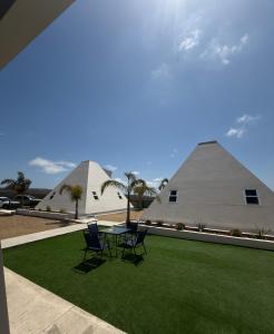 a table and chairs in front of two large tents at Villas Safir en Valle de Gpe in Los Hornos