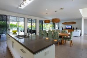 a kitchen and dining room with a table and chairs at Yaroomba Beach House in Yaroomba