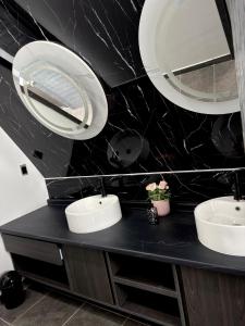 a bathroom with two sinks and a mirror at Villas Safir en Valle de Gpe in Los Hornos +29 photos