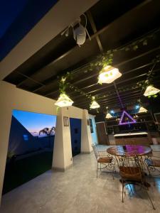 a room with a table and chairs and lights at Villas Safir en Valle de Gpe in Los Hornos