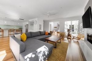 a living room with a couch and a table at Seaside Beach House in Marcoola