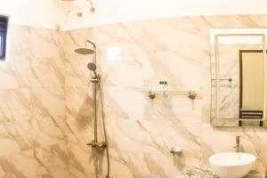 a bathroom with a shower and a sink at Unawa Retreat in Tissamaharama +105 photos