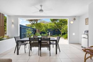 a dining room with a table and chairs at Peregian on the Beach Apt 1 in Peregian Beach