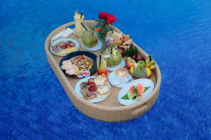 a table of food on a boat in the water at Sevn Legian in Legian