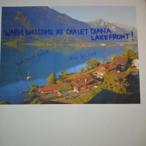 a painting of a village on a lake at Chalet Diana Lakefront in Ringgenberg
